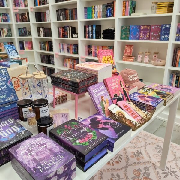 Romance novels stacked on the front table of Evermore Books