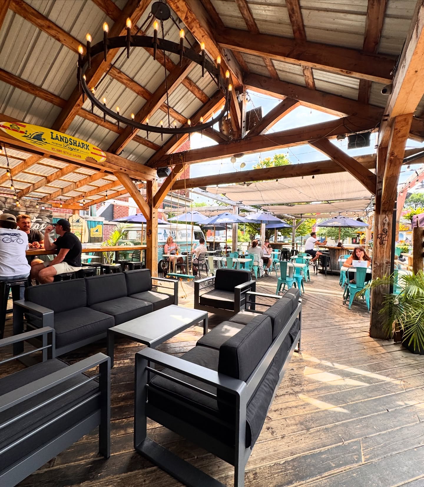A full patio under timber beams on a summer evening on Bank Street